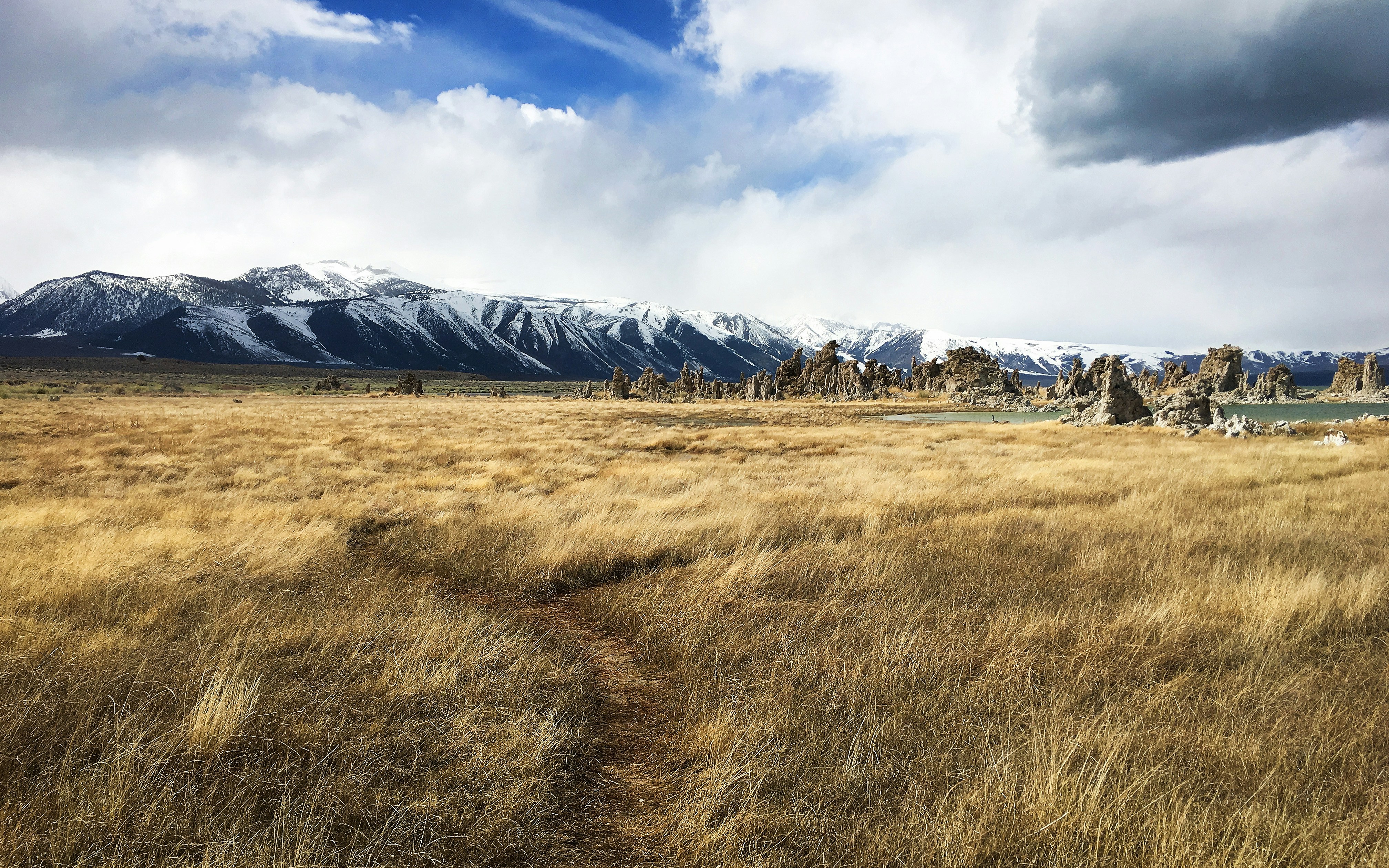 Camper van on US-395 Eastern Sierra Nevada with granite mountains and sagebrush desert