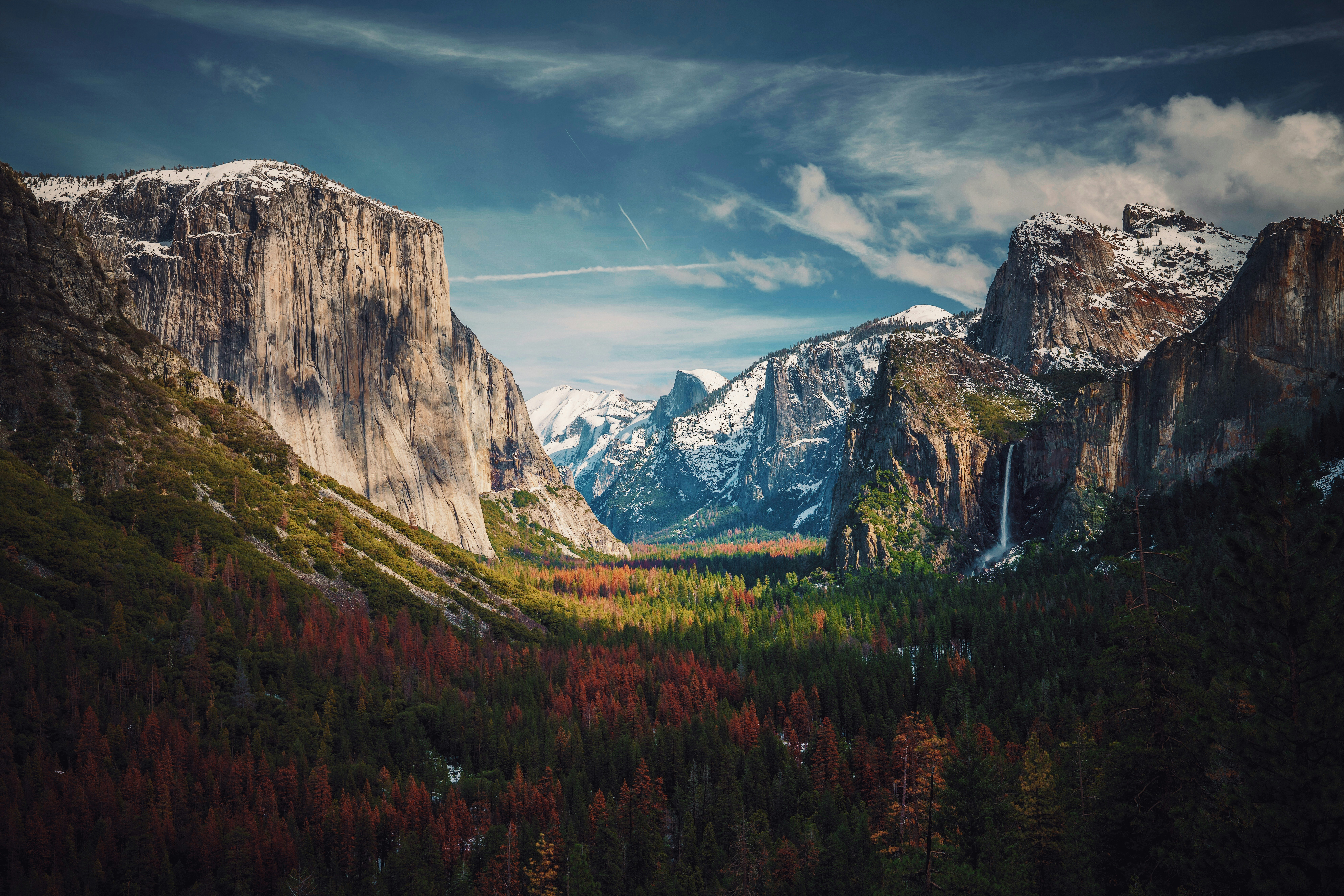 Camper van in Yosemite Valley with El Capitan granite wall in background